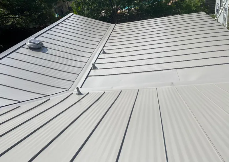 Solar attic fan installed on a metal roof for Roof Ventilation in Sabattus